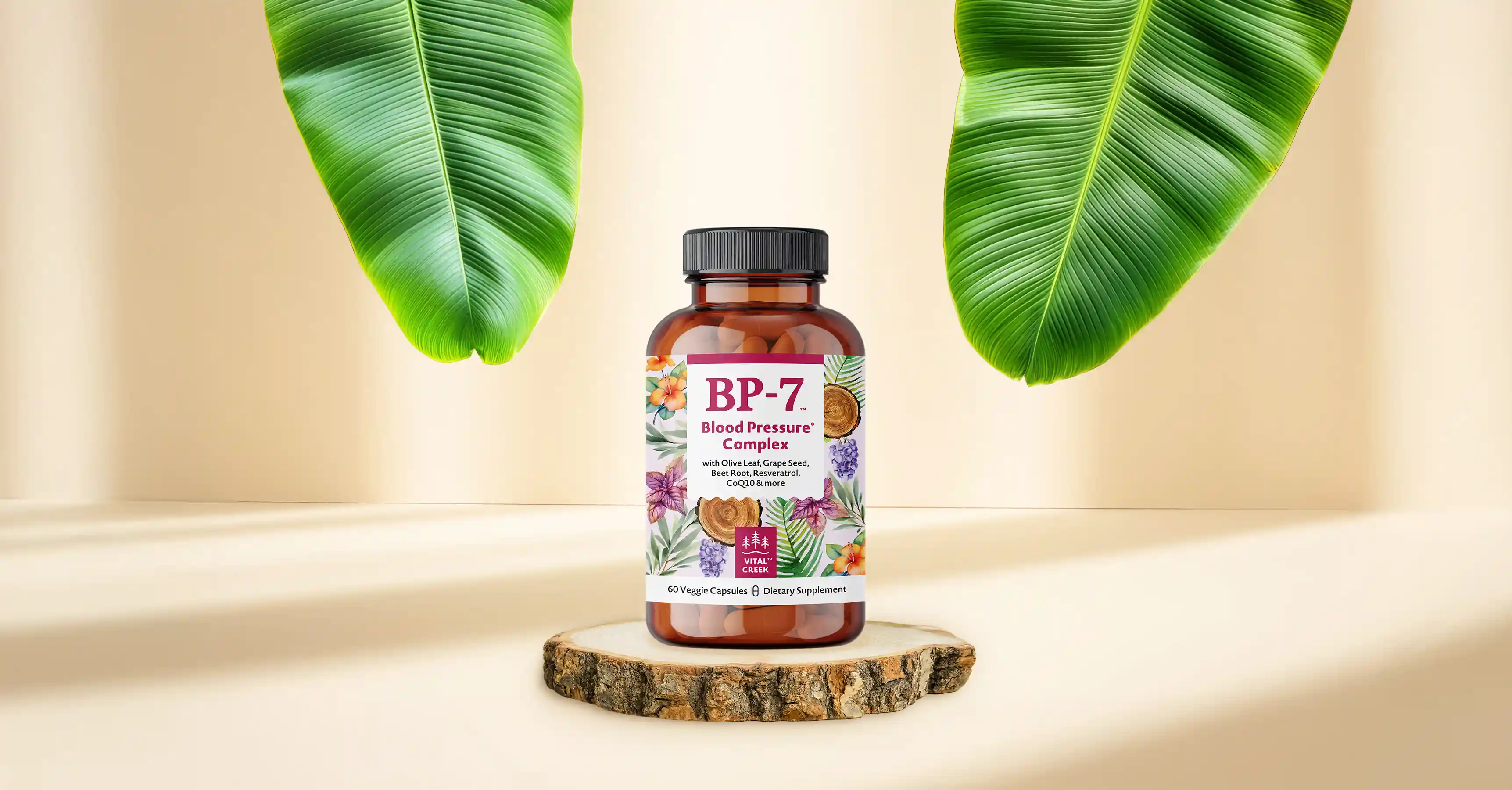 Vital Creek BP-7 bottle on a cream-colored table with banana tree leaves in the background